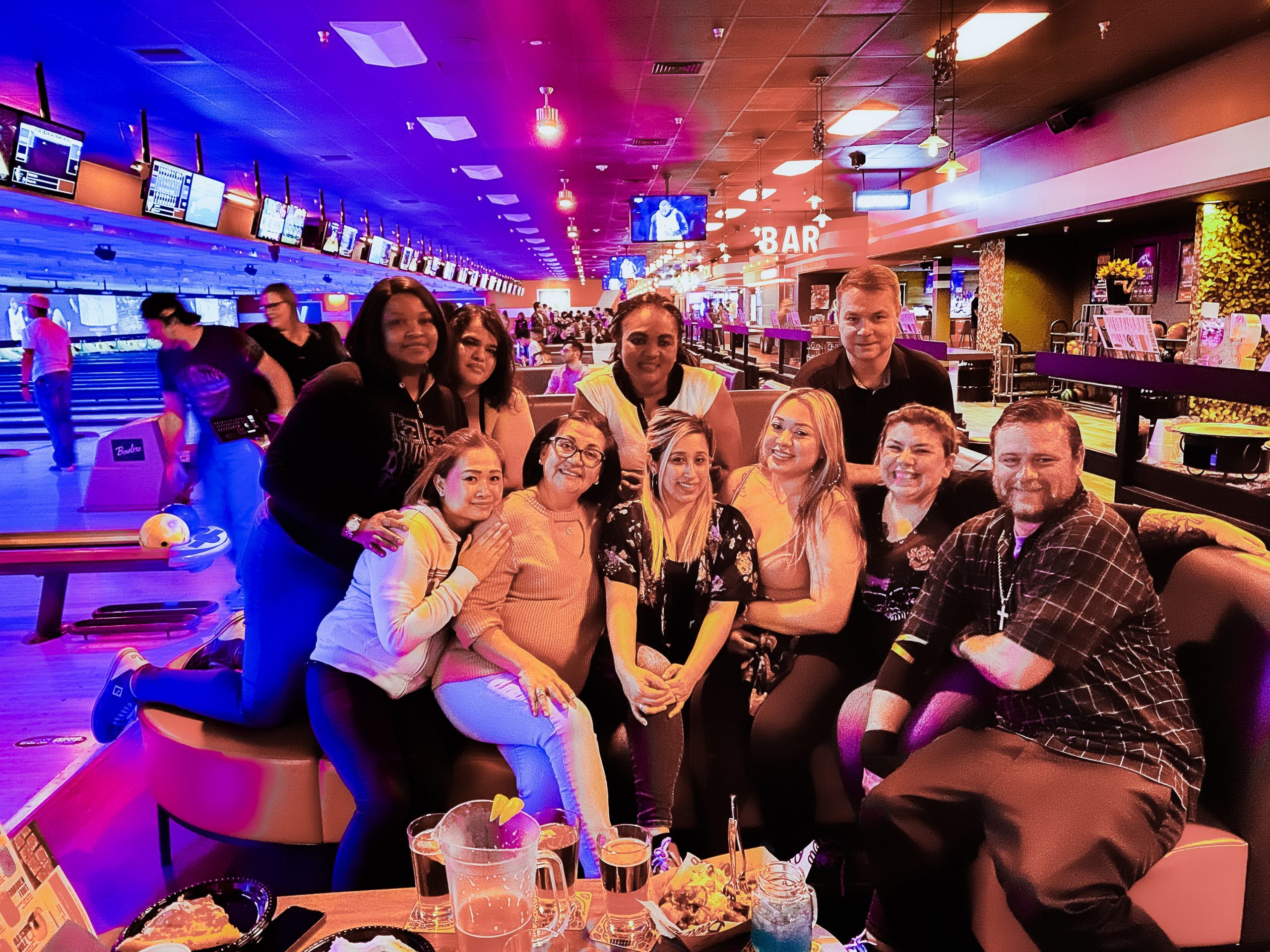 people posing at a bowling alley